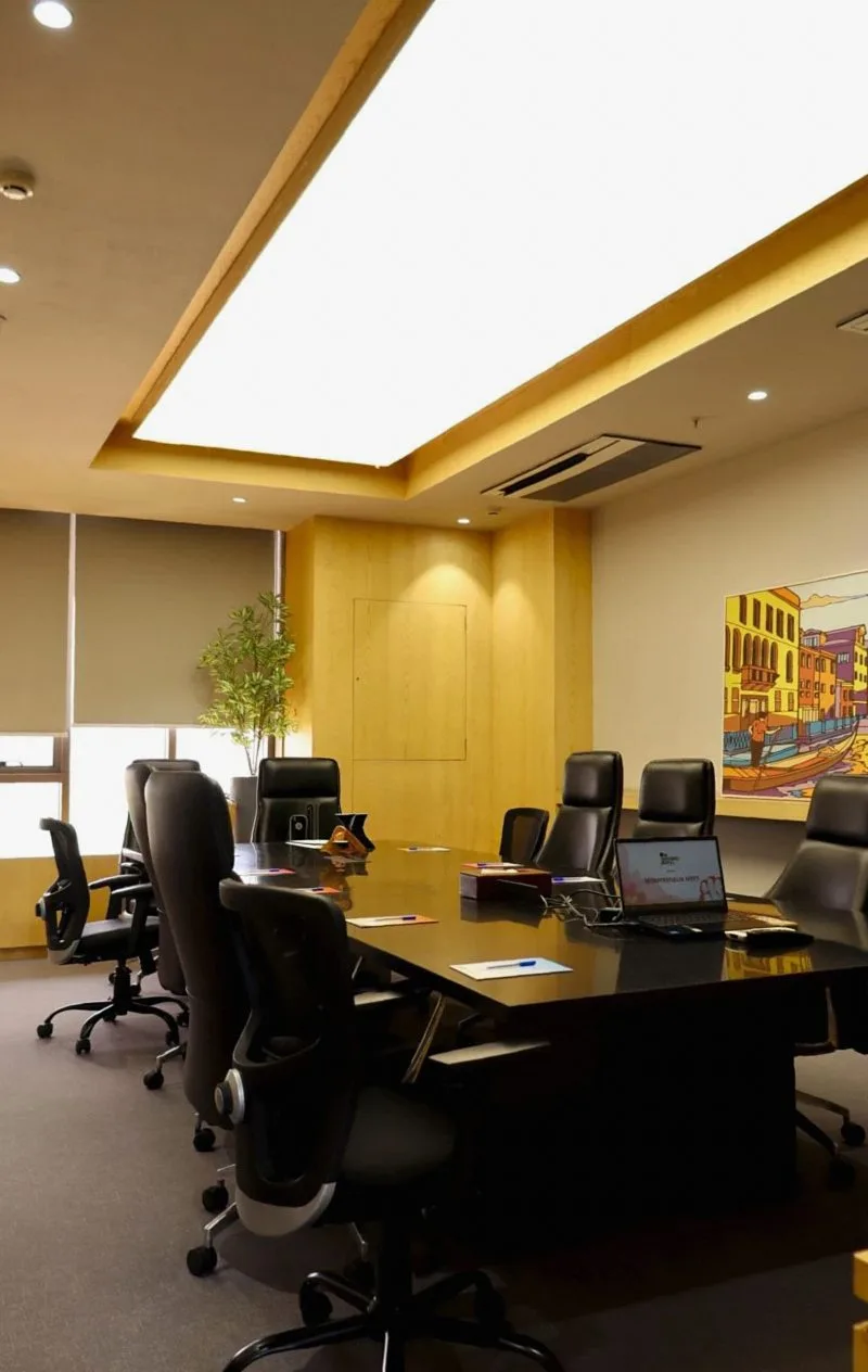 Meeting room with a long table and dark leather chairs